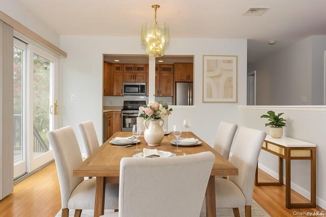 33 Hillcrest Road Suffern, NY 10901 - Photo 11 of 39 Staged - Dining room with a chandelier and light wood-style floors