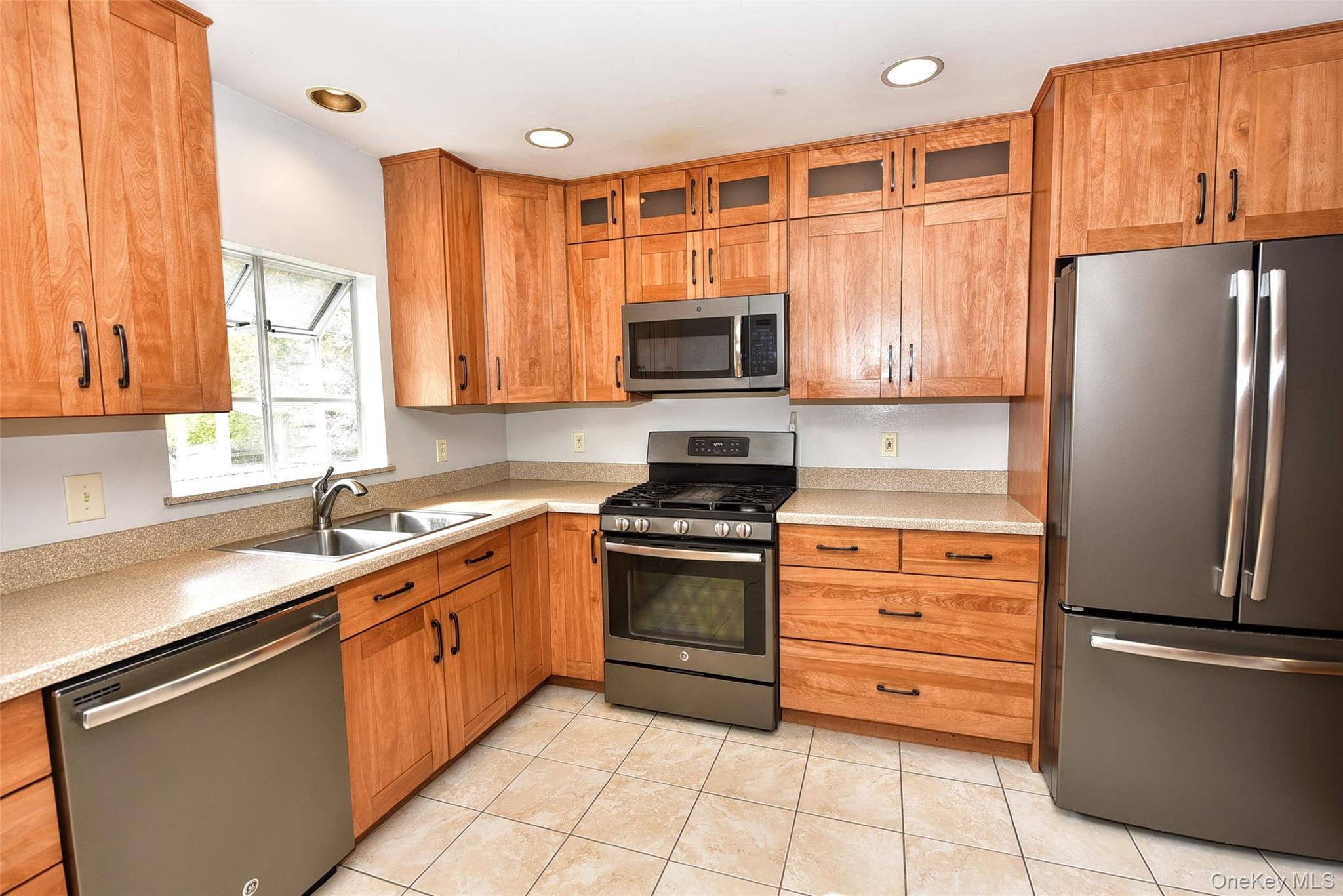 33 Hillcrest Road Suffern, NY 10901 - Photo 12 of 39 Kitchen with stainless steel appliances, glass insert cabinets, light countertops, light tile patterned floors, and recessed lighting