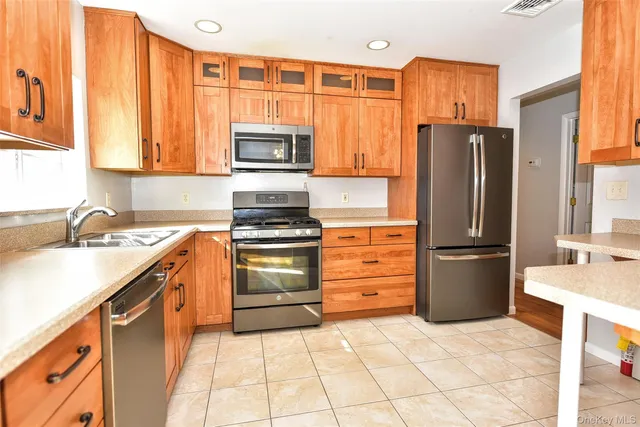 a kitchen with stainless steel appliances granite countertop a stove and a sink