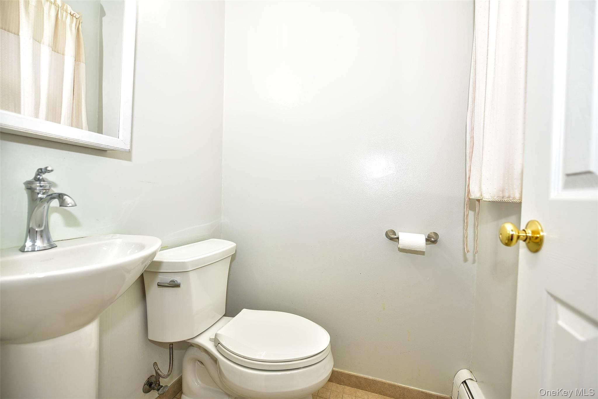 33 Hillcrest Road Suffern, NY 10901 - Photo 17 of 39 Bathroom featuring a baseboard heating unit and curtained shower