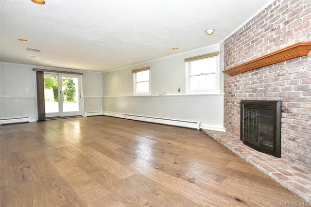 a living room with furniture a window and a fireplace