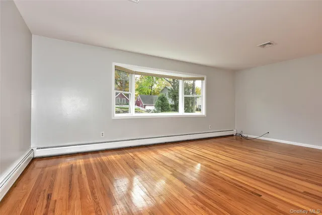 a living room with furniture a flat screen tv and a large window