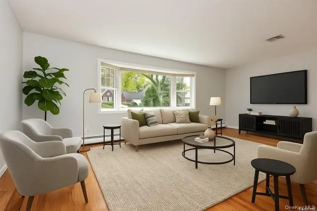 a view of a room with wooden floor and a window