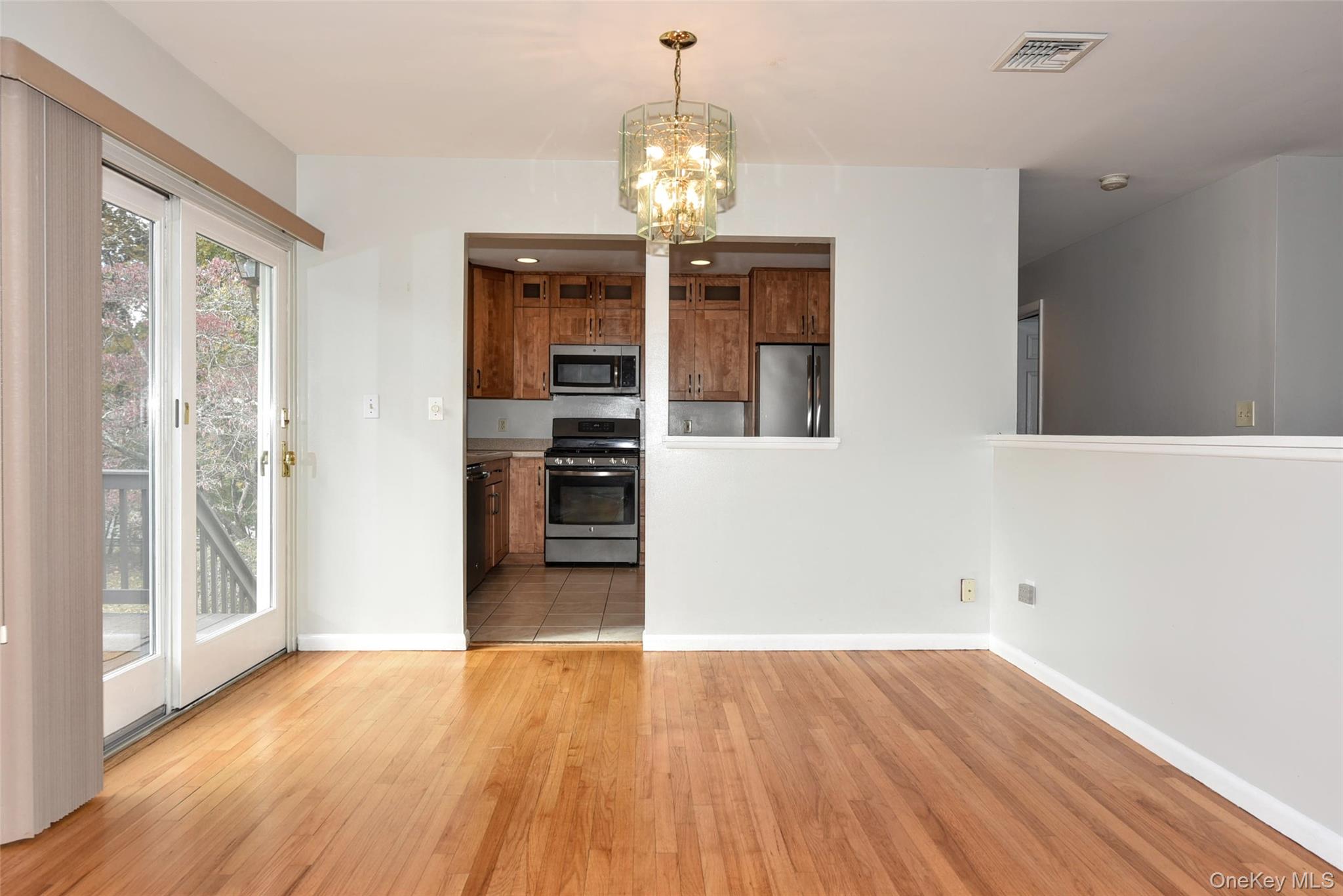 33 Hillcrest Road Suffern, NY 10901 - Photo 10 of 39 Unfurnished dining area with a chandelier and light wood-type flooring