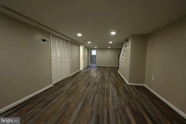 a view of hallway with wooden floor