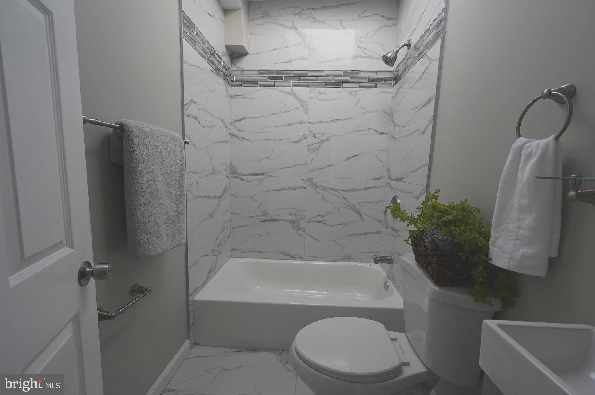 3303 Westerwald Avenue Baltimore, MD 21218 - Photo 6 of 28 a bathroom with a toilet and a bath tub