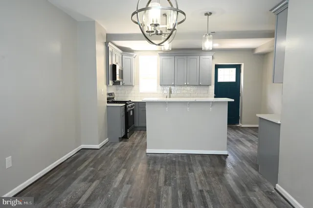 a view of kitchen with cabinets and wooden floor