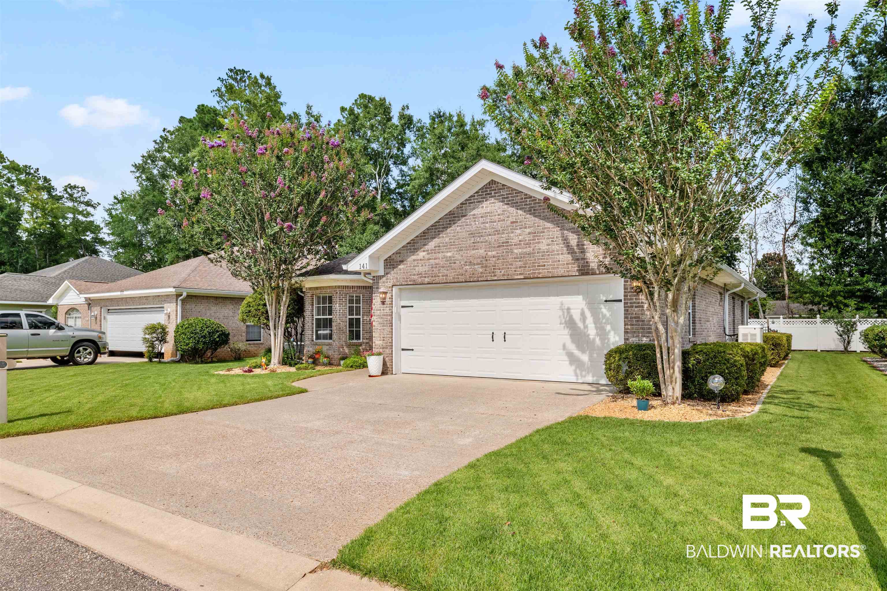 141 Mark Twain Loop Foley, AL 36535 - Photo 2 of 55 Ranch-style house with concrete driveway, an attached garage, and brick siding