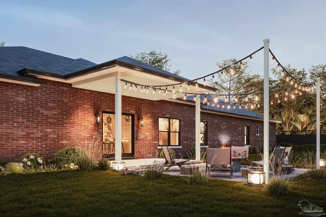 a view of a house with backyard sitting area and garden
