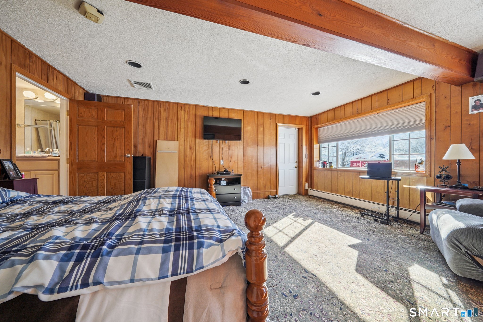 10 Algonquin Road Norwalk, CT 06851 - Photo 15 of 24 Lower level with wood beams, wall-to-wall carpeting, built-ins and access to garage can easily be transformed into a large family room! Natural light is no problem for this space!