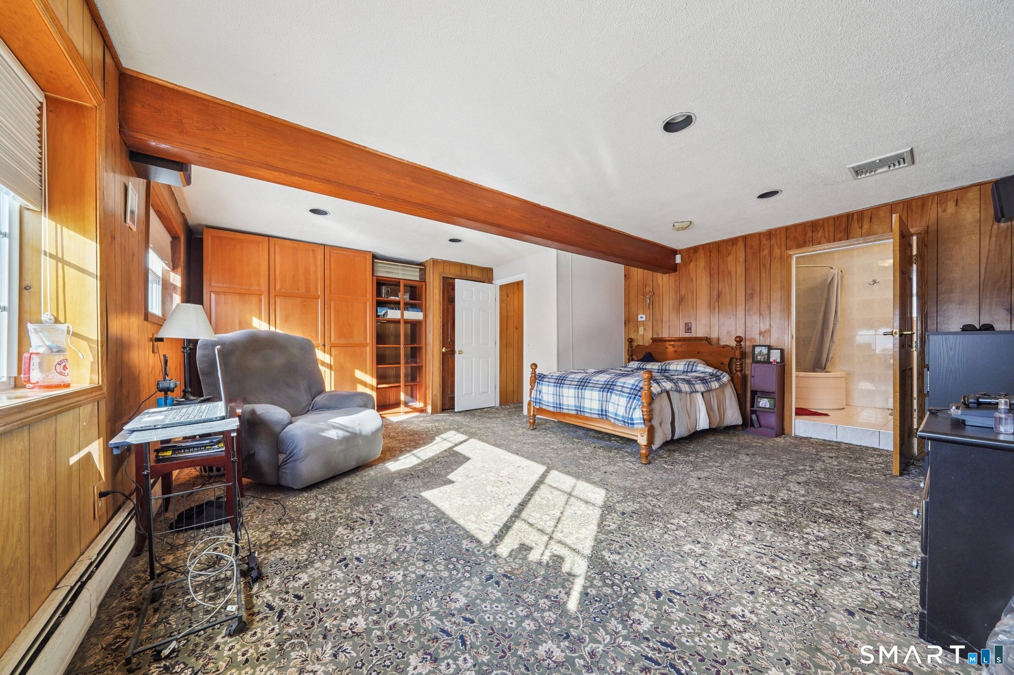 10 Algonquin Road Norwalk, CT 06851 - Photo 16 of 24 Lower level with wood beams, wall-to-wall carpeting, built-ins and access to garage can easily be transformed into a large family room! Natural light is no problem for this space!
