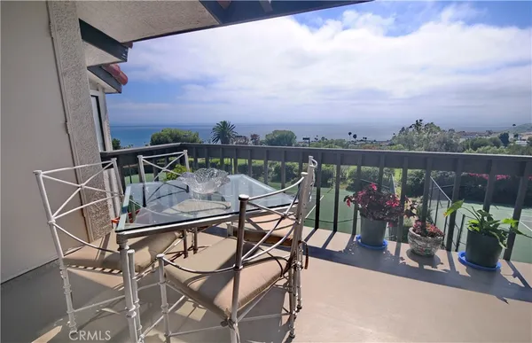a view of a balcony with furniture and wooden floor