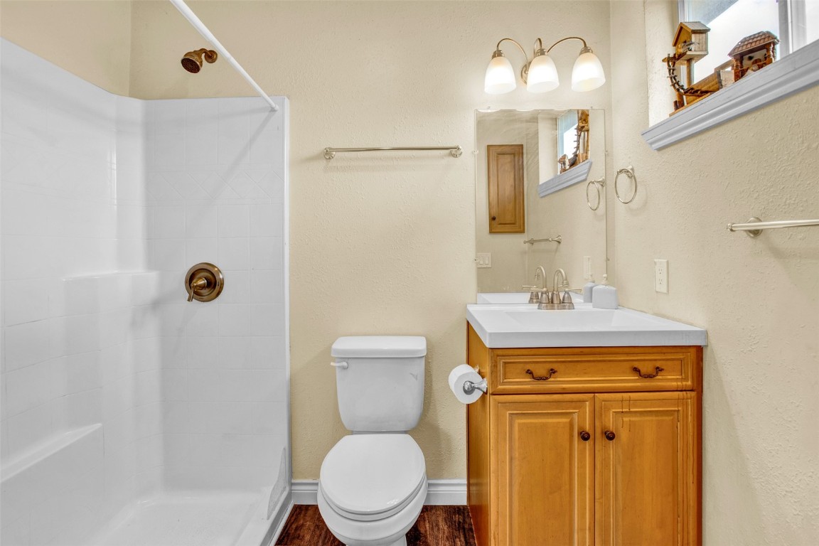 59 Chief Trail Como, CO 80456 - Photo 15 of 44 a bathroom with a toilet sink vanity and mirror