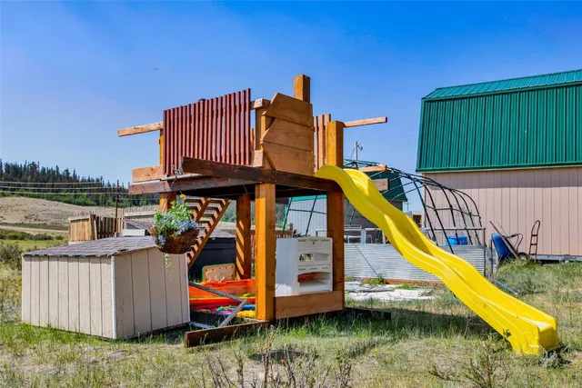 a view of a house with swimming pool and sitting area