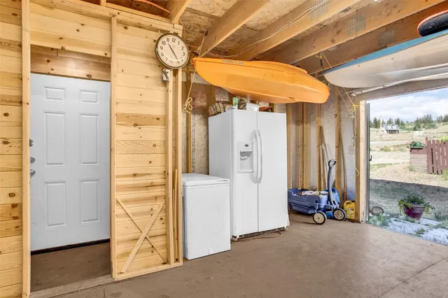 a kitchen with stainless steel appliances granite countertop a refrigerator a stove and a sink