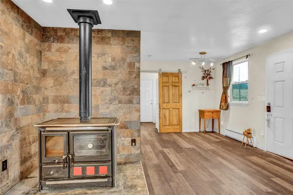 a living room with a refrigerator and a table