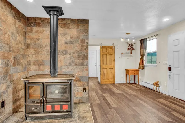 a living room with a refrigerator and a table