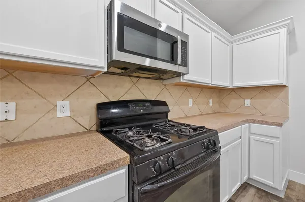 a kitchen with a stove and a microwave