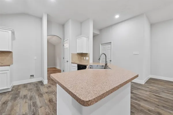 a kitchen with kitchen island a sink stainless steel appliances and cabinets
