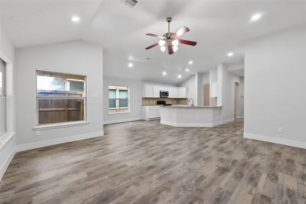 a view of a kitchen with a sink and microwave