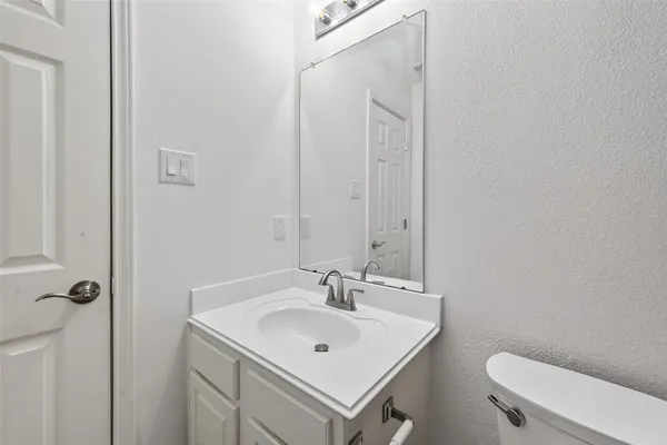 a bathroom with a sink toilet and a mirror