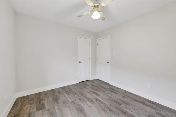 a view of a room with wooden floor