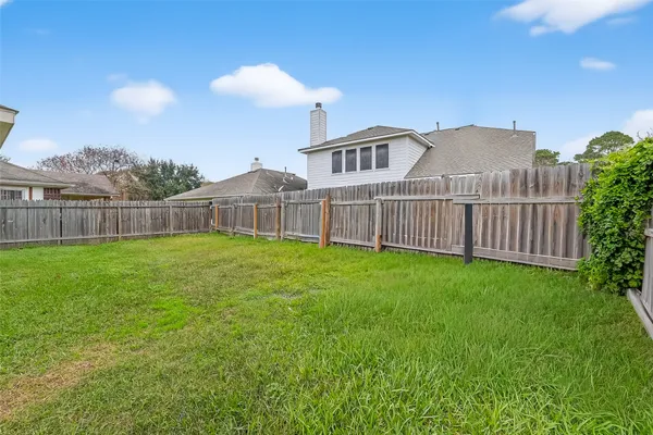 a view of a house with a yard and sitting area