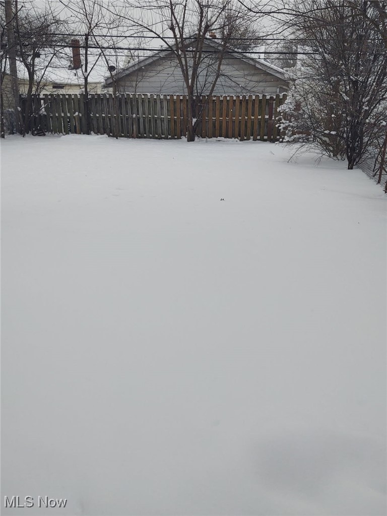 21216 Watson Road Maple Heights, OH 44137 - Photo 2 of 6 Yard covered in snow with fence