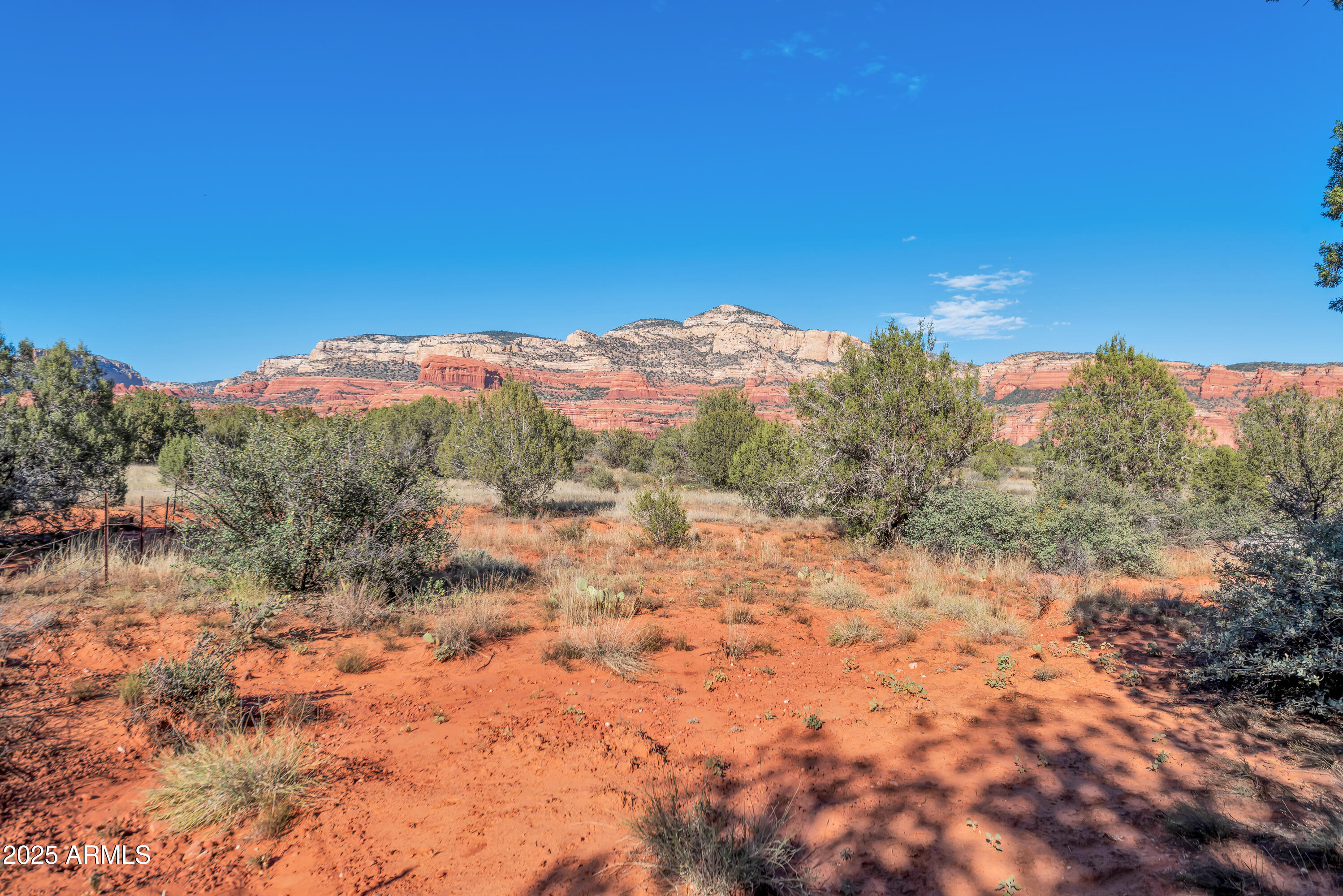 75 Estrella Road, Unit 3 Sedona, AZ 86336 - Photo 3 of 28 a view of a dry yard with mountains in the background