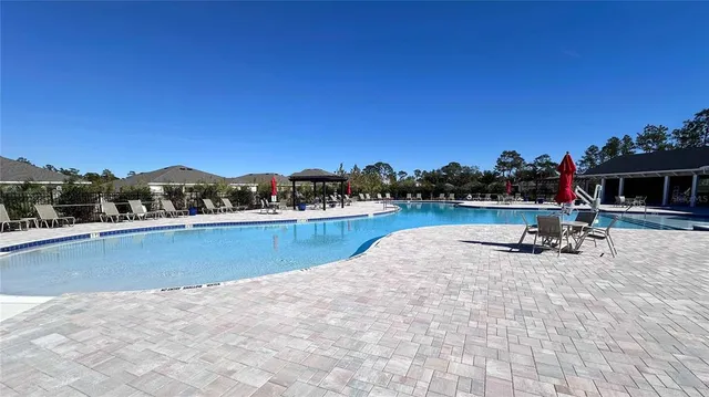 a view of a swimming pool with lounge chair