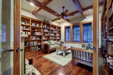 a living room with furniture and a book shelf