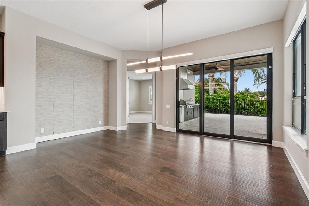 10605 Sabella Drive Trinity, FL 34655 - Photo 23 of 77 a view of a room with wooden floor and a floor to ceiling window