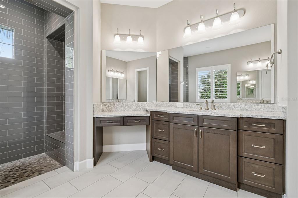 10605 Sabella Drive Trinity, FL 34655 - Photo 29 of 77 a bathroom with a granite countertop sink mirror and double