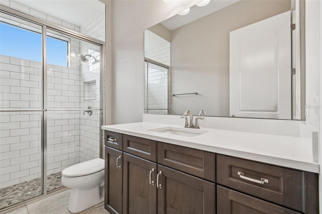 10605 Sabella Drive Trinity, FL 34655 - Photo 35 of 77 a bathroom with a sink a toilet and shower