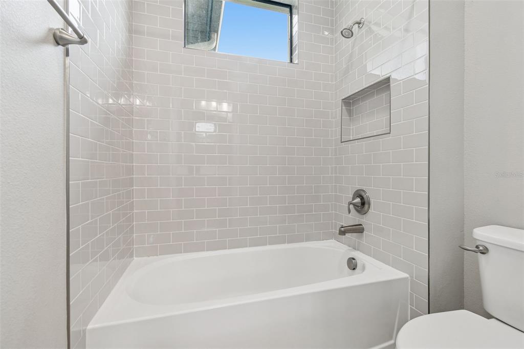 10605 Sabella Drive Trinity, FL 34655 - Photo 38 of 77 a bathroom with a bathtub and a toilet