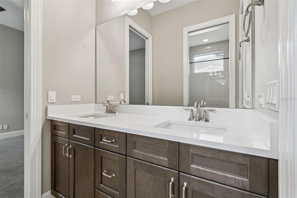 10605 Sabella Drive Trinity, FL 34655 - Photo 39 of 77 a bathroom with a sink double vanity and a mirror