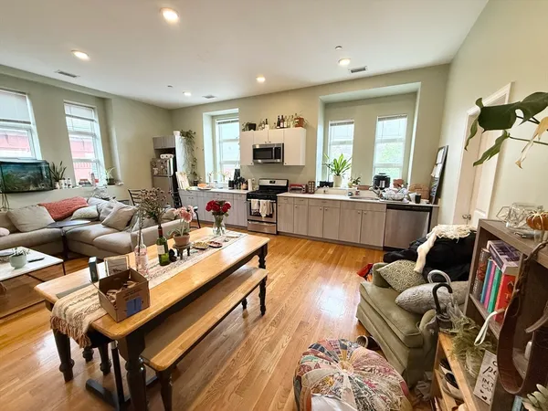 a living room with furniture fireplace and a table