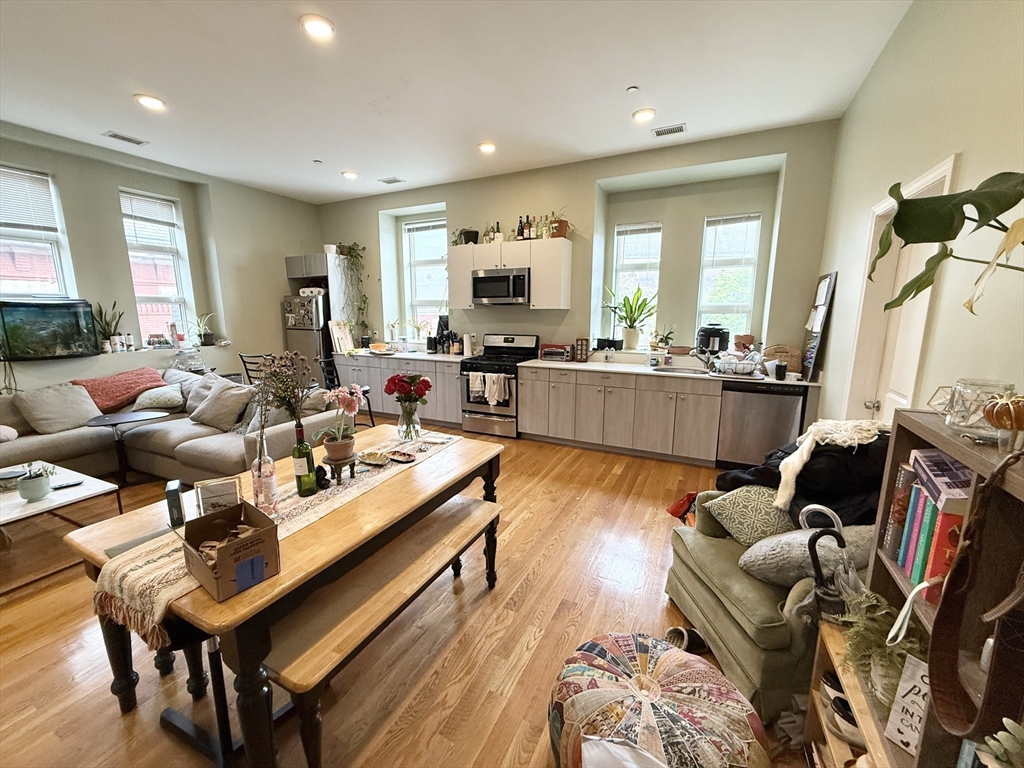 a living room with furniture fireplace and a table