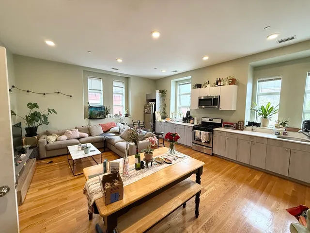 a living room with fireplace furniture and a wooden floor