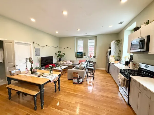 a living room with fireplace furniture and a flat screen tv