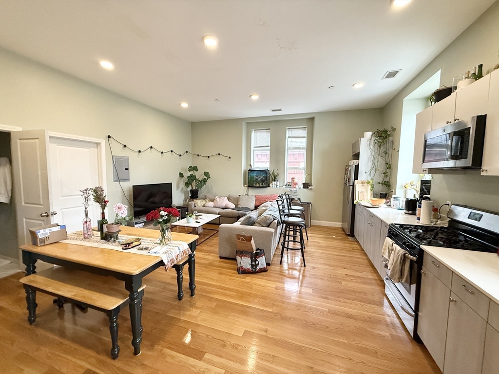 409 Dudley Street, Unit 4 Boston, MA 02119 - Photo 3 of 10 a living room with fireplace furniture and a flat screen tv