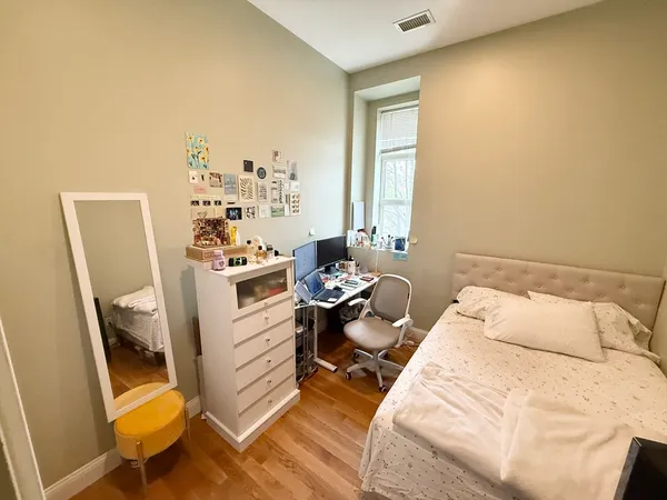 a bed room with a bed and a chair