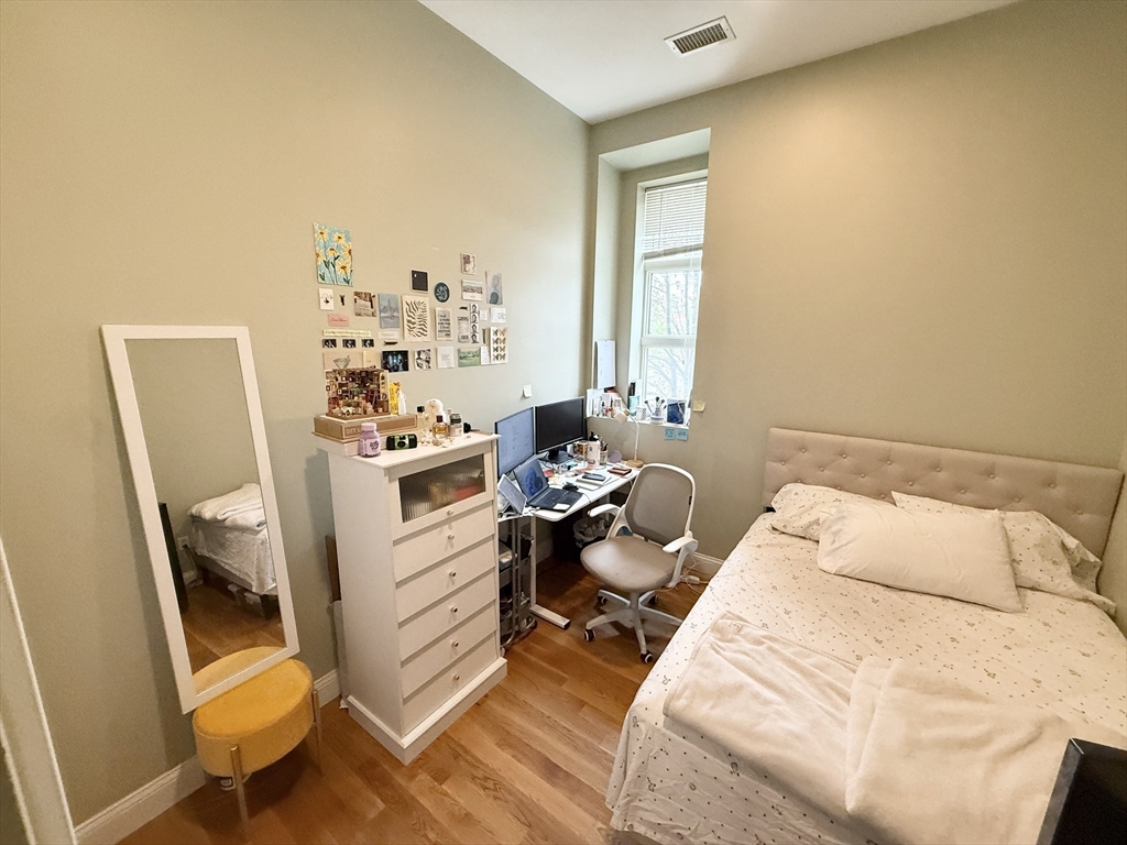 409 Dudley Street, Unit 4 Boston, MA 02119 - Photo 4 of 10 a bed room with a bed and a chair