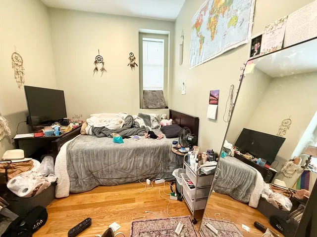 a bedroom with a bed and flat screen tv
