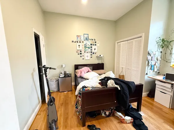 a bed sitting in a bedroom next to a window