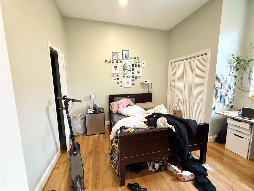 409 Dudley Street, Unit 4 Boston, MA 02119 - Photo 8 of 10 a bed sitting in a bedroom next to a window