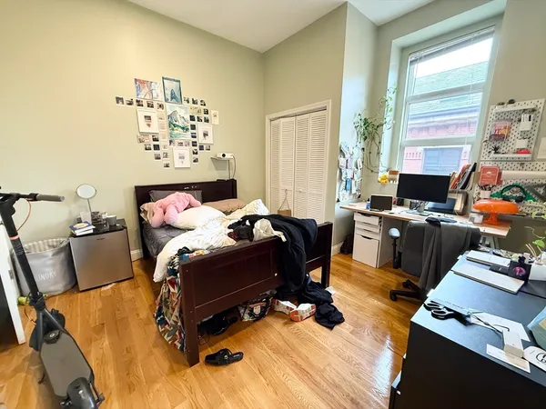 a bedroom with furniture and a window