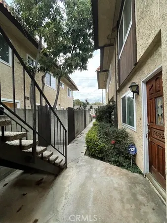 a view of a house with street next to a road