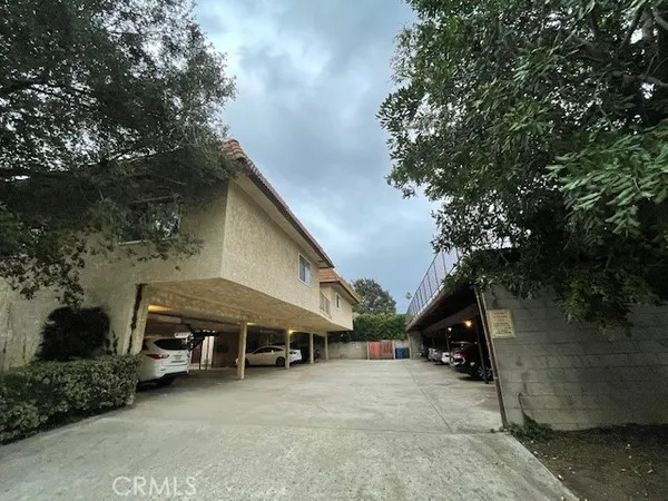a view of a house with a yard and wooden fence