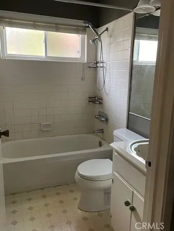 a bathroom with a toilet a sink and bathtub
